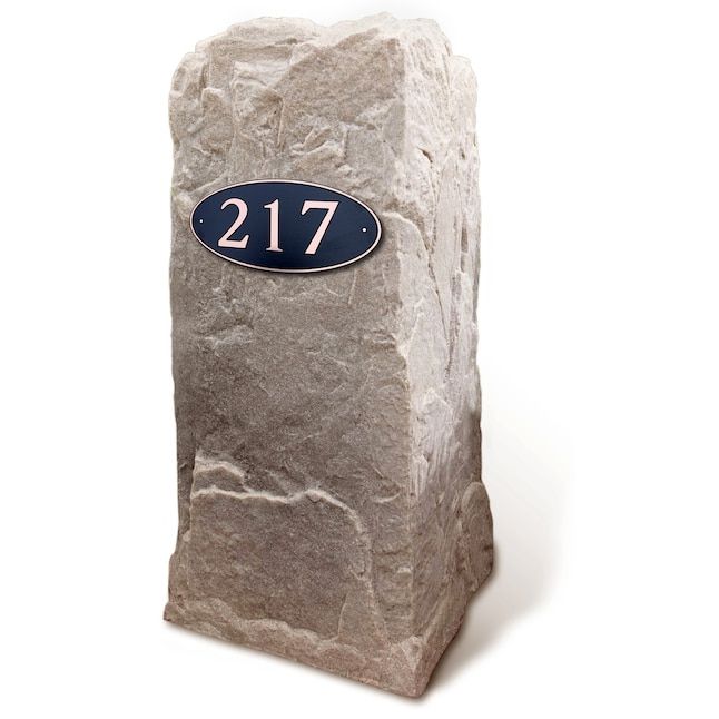 a stone block with the number twenty seven on it and a blue plaque that reads, 21 / 7