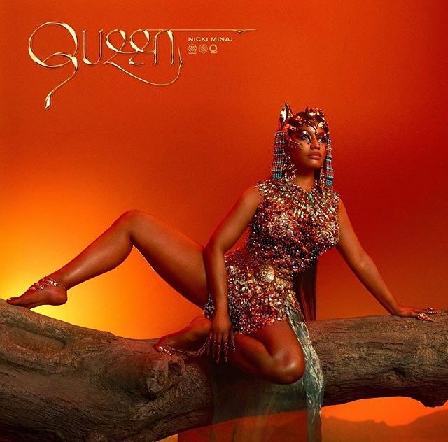 a woman sitting on top of a tree branch in front of an orange background with the word queen written across it