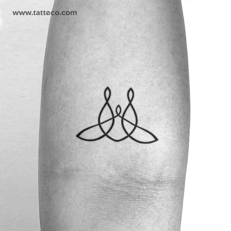 a black and white photo of a tattoo design on the leg, with an image of two