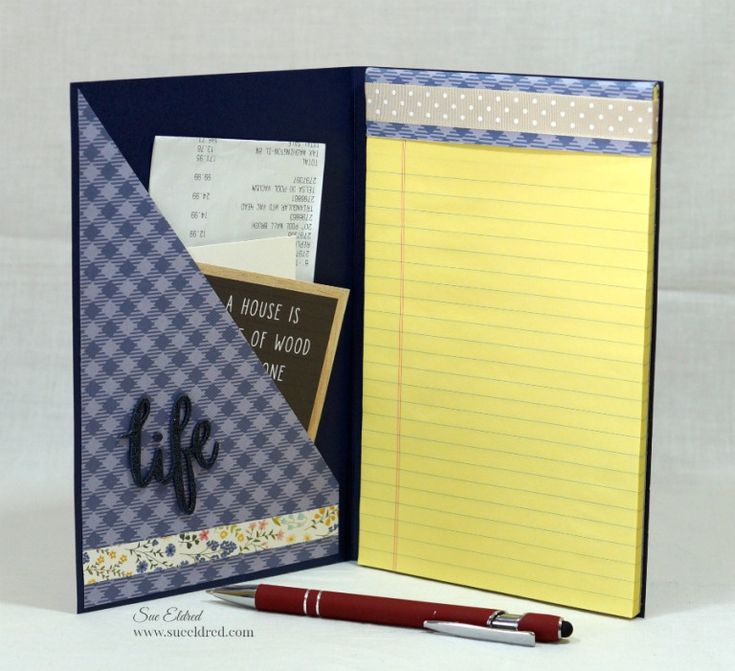 an open notebook with writing on it and a note pad next to it, along with a red pen