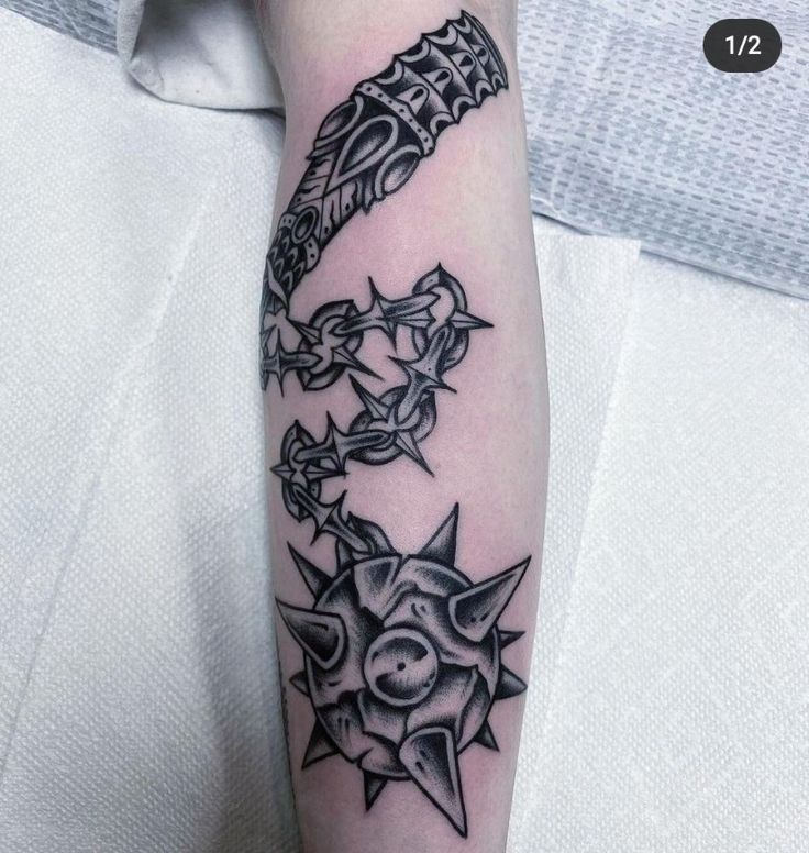 a black and white tattoo design on the arm