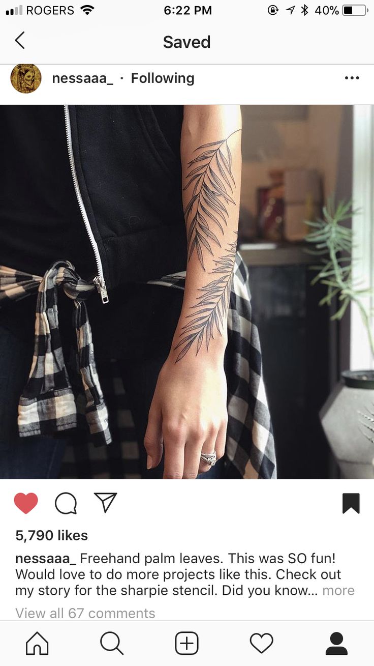 a person with a tattoo on their arm is holding something in her hand and the other hand has an arrow