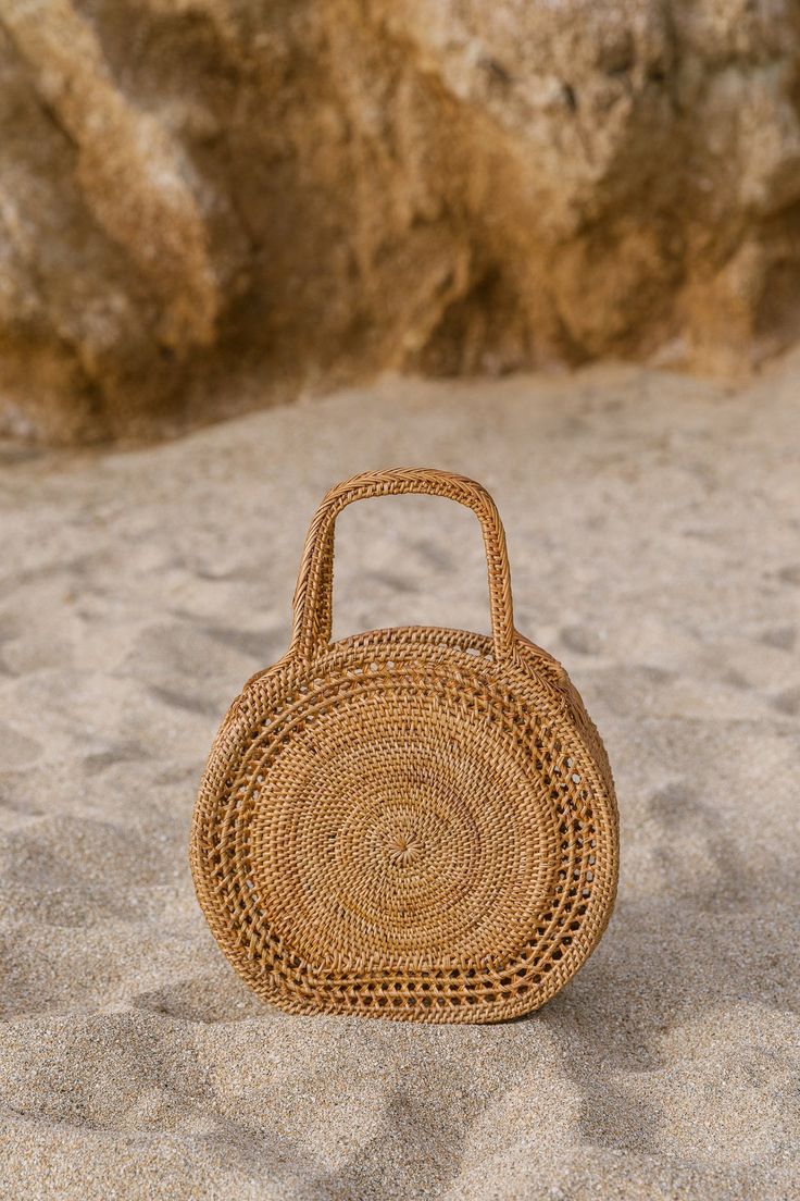 Collection of Tenganan Basket Bags against a sand background. - Saffron and Poe Oversized Lumbar Pillow, Basket Handbag, Purse Outfit, Euro Pillows, Handwoven Throw, Elevated Casual, Concentric Circles, Amazing Ideas, Daily Necessities