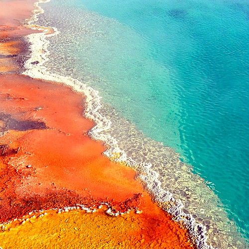 an aerial view of the water and land in this area is blue, green, yellow, and orange