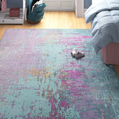 a bedroom with blue walls and pink rugs