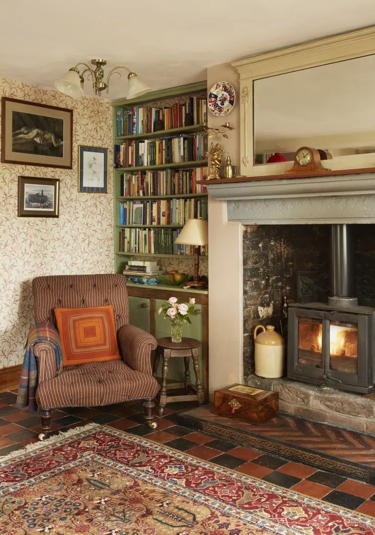 a living room filled with furniture and a fire place in front of a book shelf