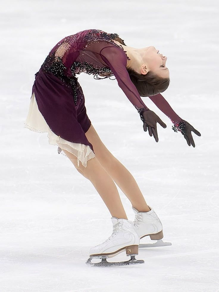 a female figure skating on an ice rink