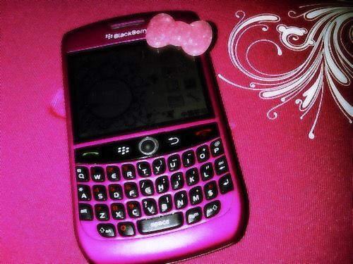 a cell phone with a pink bow on it