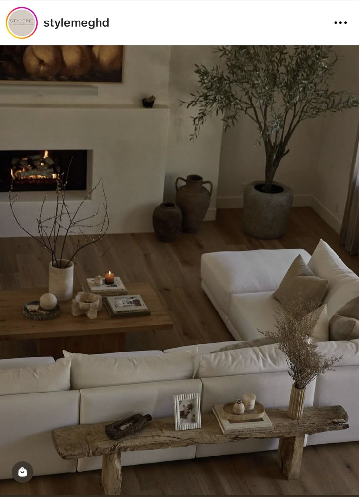 a living room filled with furniture and a fire place in the middle of the room