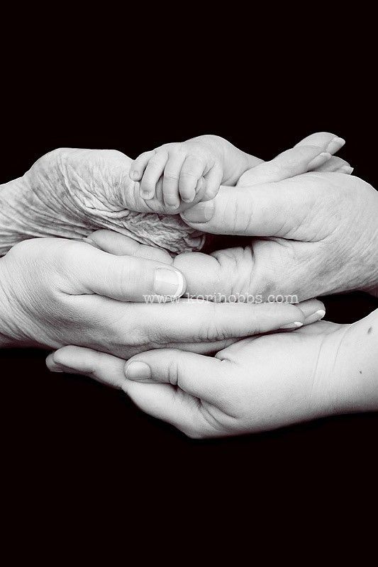 two adults and one child holding their hands together