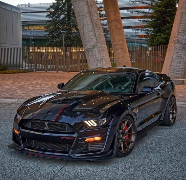 a black sports car parked in front of some palm trees