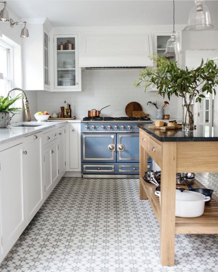 a kitchen filled with lots of white and blue appliances