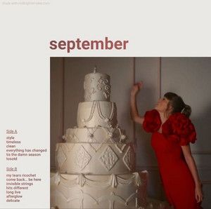 a woman in a red dress standing next to a large white cake with flowers on it