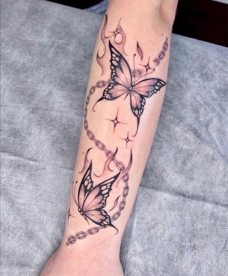 a woman's leg with butterfly tattoos on it