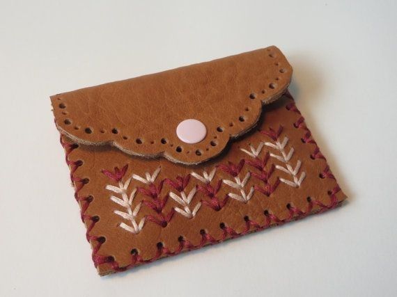 a brown wallet sitting on top of a white table