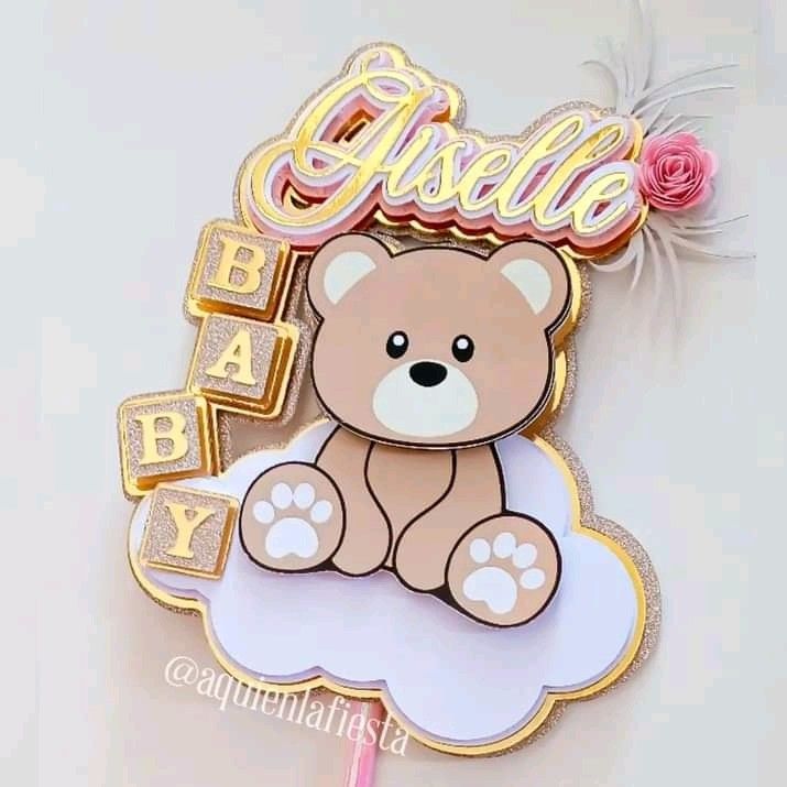 a teddy bear is sitting on top of a cloud with the word baby spelled in gold