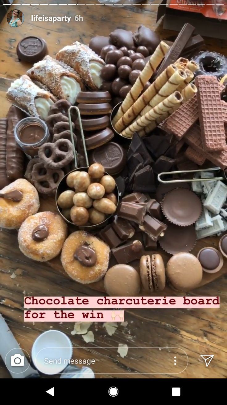 there is a large display of chocolates and donuts on the table with words above it