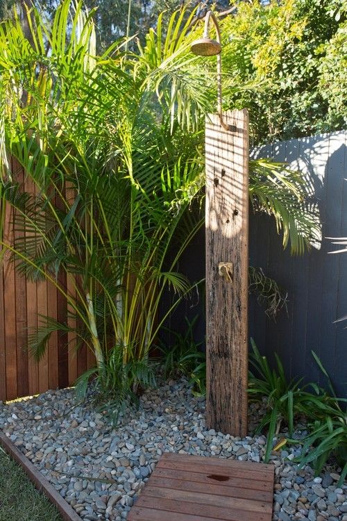 a wooden pole sitting in the middle of a garden