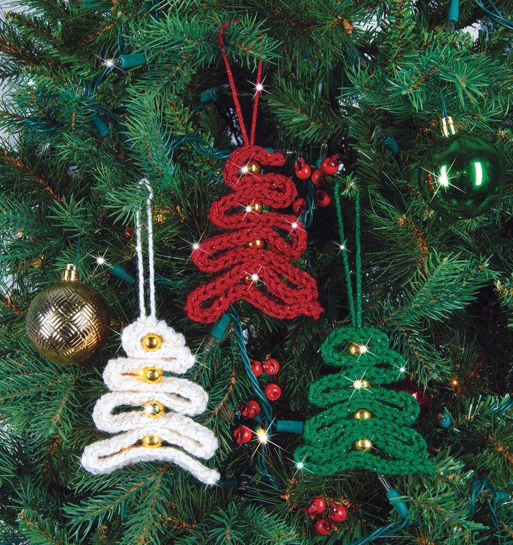 crocheted christmas ornaments hanging from a tree