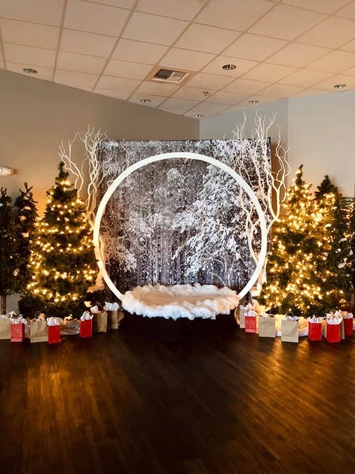 christmas trees and presents are on the floor in front of a wall with a circle