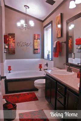 a bathroom with red rugs on the floor