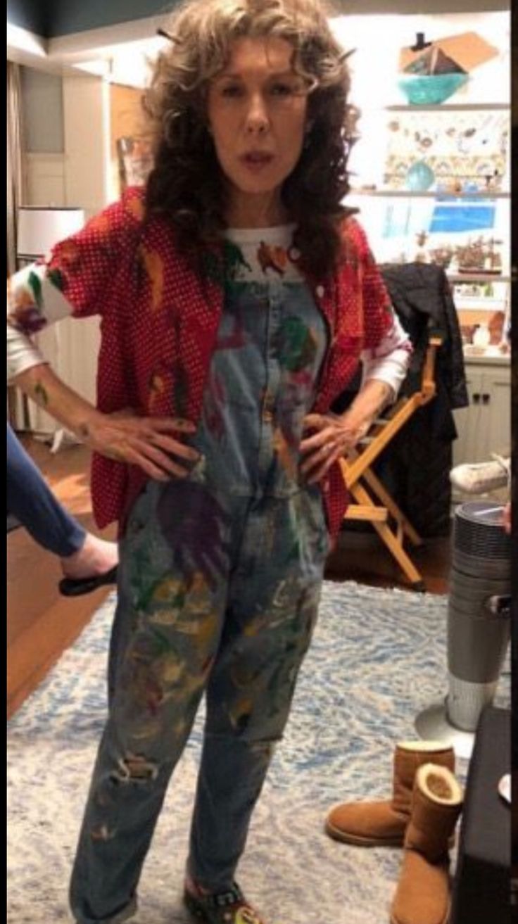 two women standing next to each other in front of a tv and wearing colorful clothing