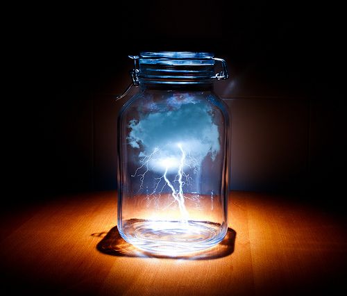 a glass jar filled with water and lightning