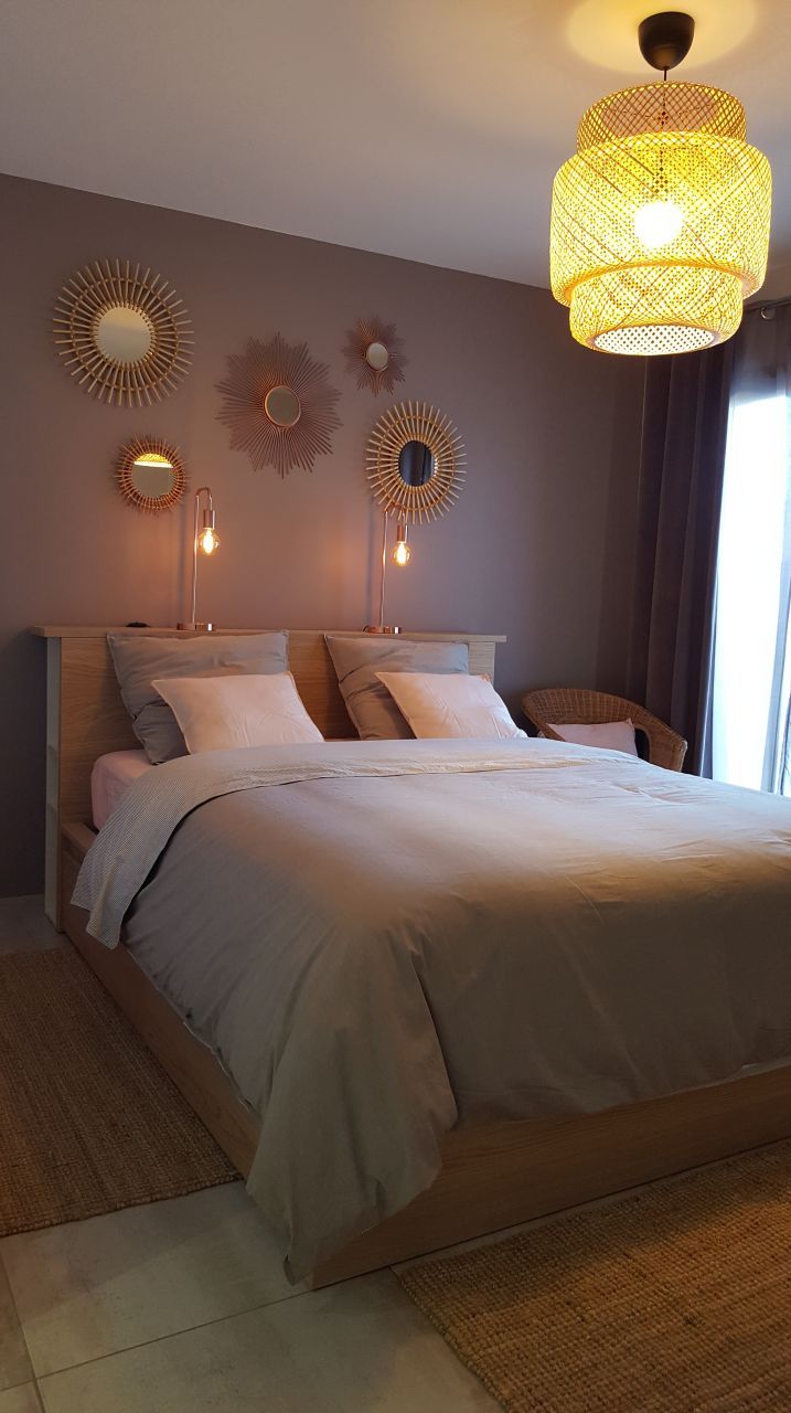 a large bed sitting in a bedroom next to two lamps on either side of it