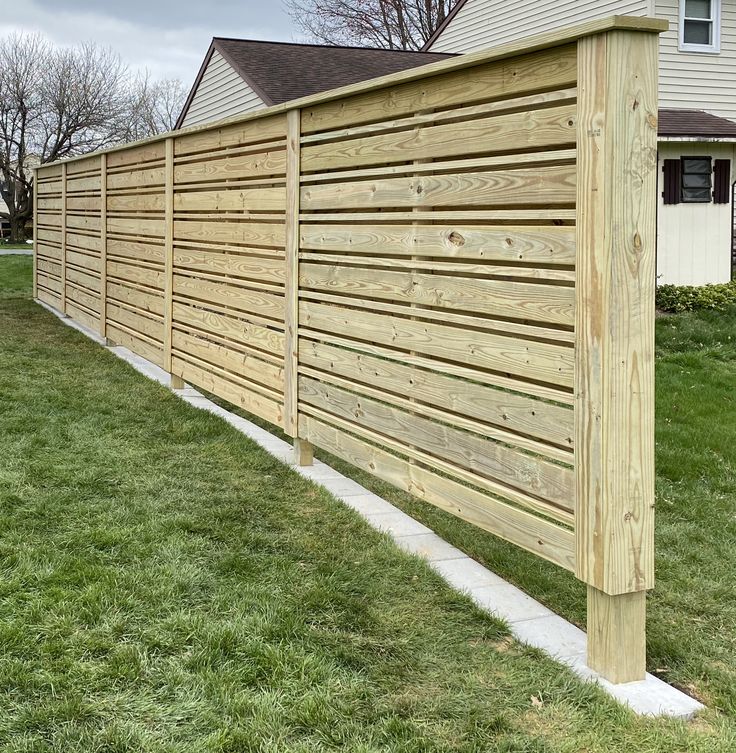 a wooden fence in front of a house