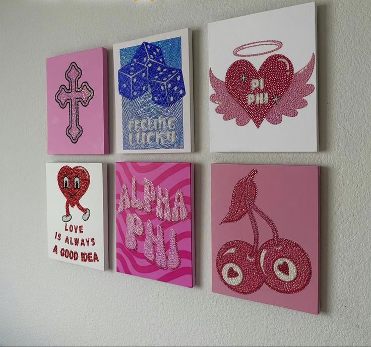 four square paintings with different designs on them hanging on the wall in front of a white wall