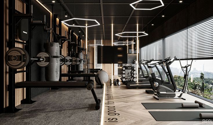 a gym with treadmills, exercise machines and windows overlooking the cityscape