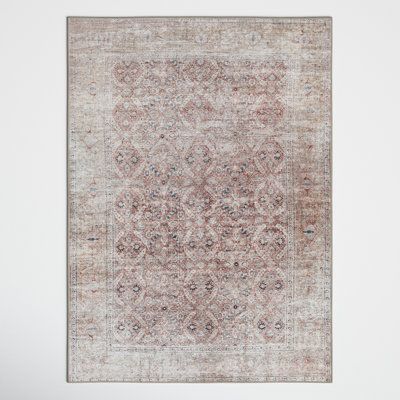 an antique rug is hanging on the wall in front of a white wall and floor