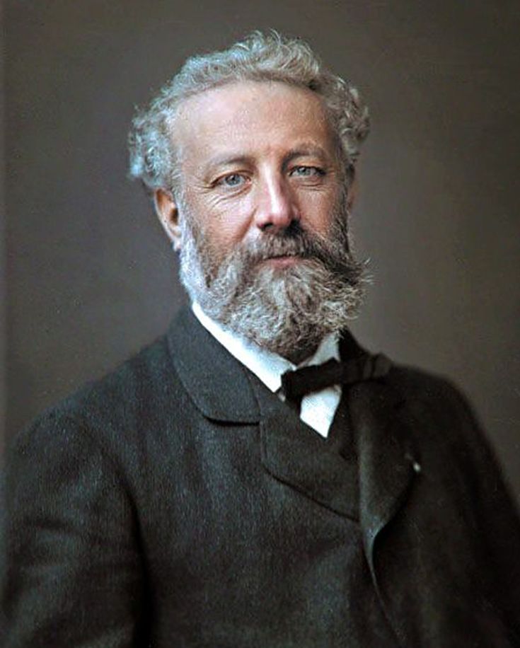 an older man with grey hair and beard wearing a suit