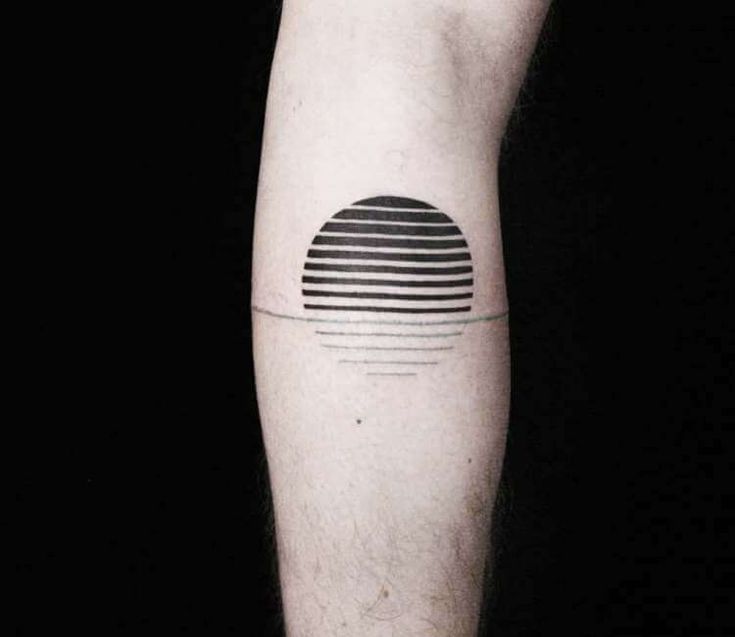 a man's arm with a black and white tattoo on it