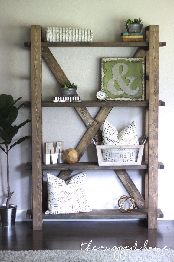 a shelf made out of wooden boards with decorative items on top and some plants in the corner