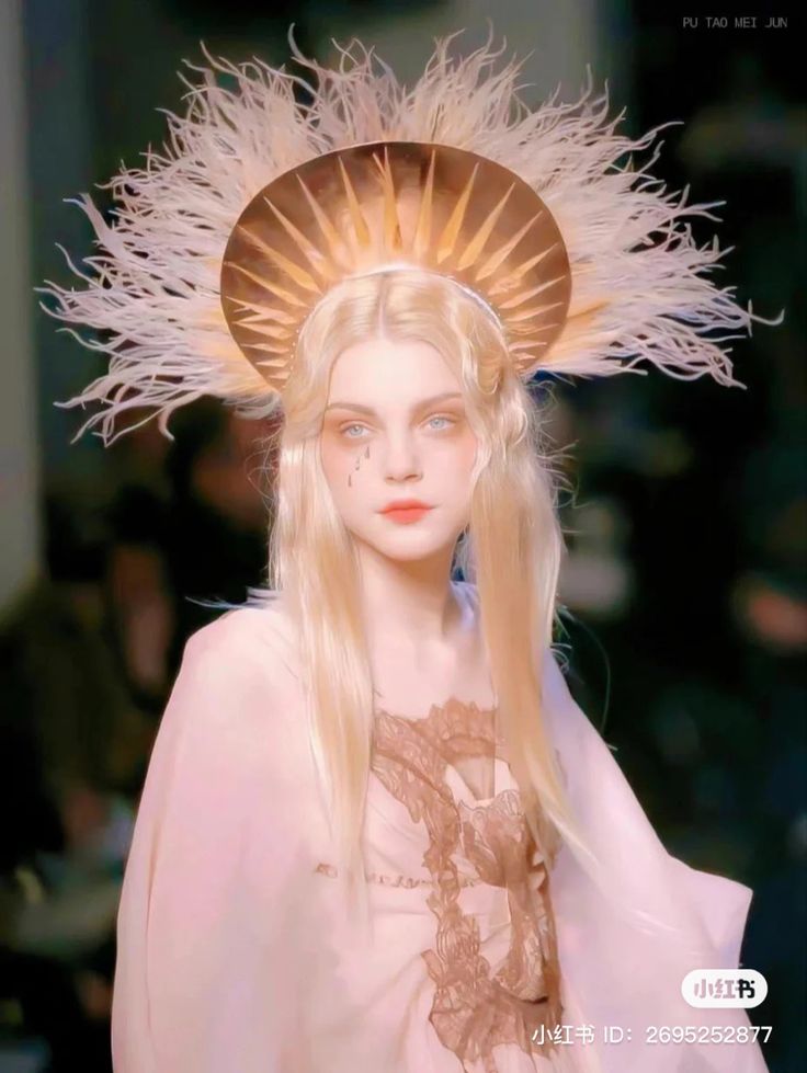 a woman with long blonde hair wearing a headdress