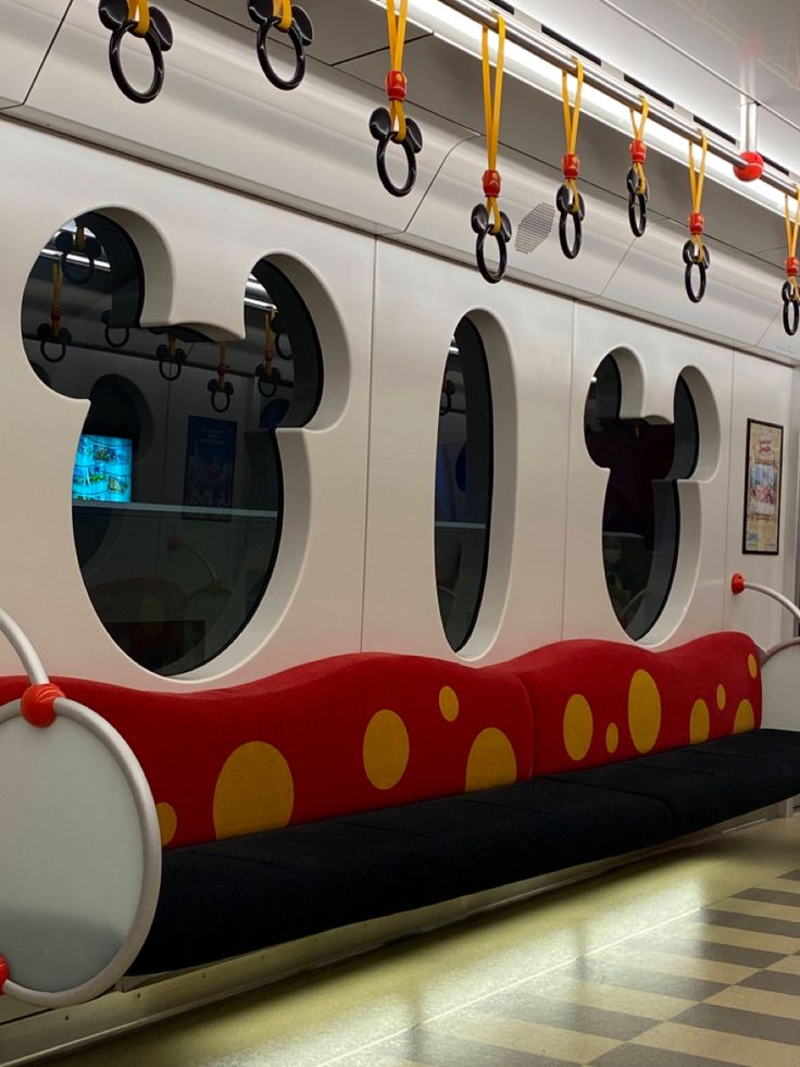 the interior of a train with mickey mouse decorations on it's side and windows