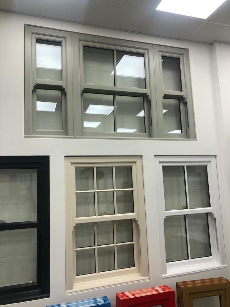 several different types of windows on display in a room with white walls and black trim