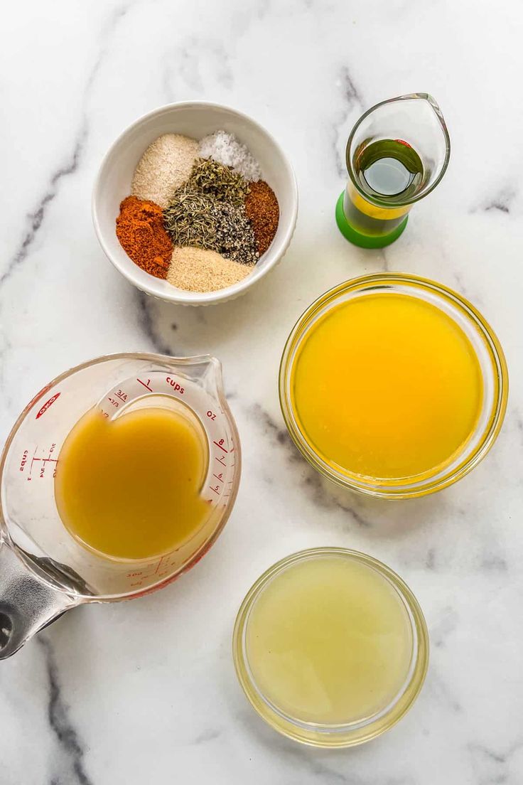 the ingredients to make an apple cider are shown in bowls on a marble countertop