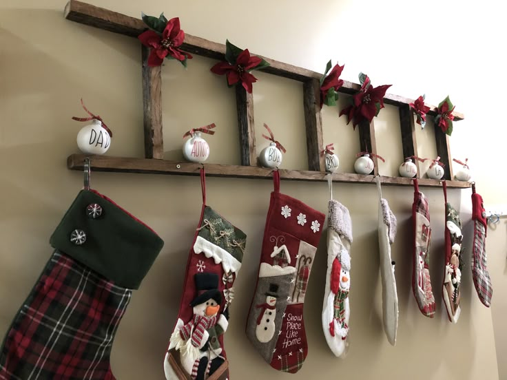 christmas stockings hanging on a wall with decorations