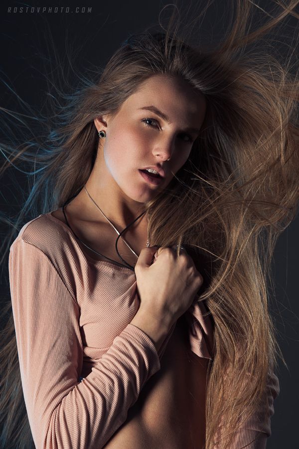 a woman with long hair is posing for the camera