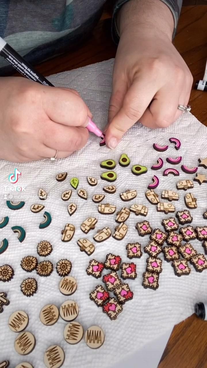 a person is working on some crafting projects with buttons and beads in the shape of flowers