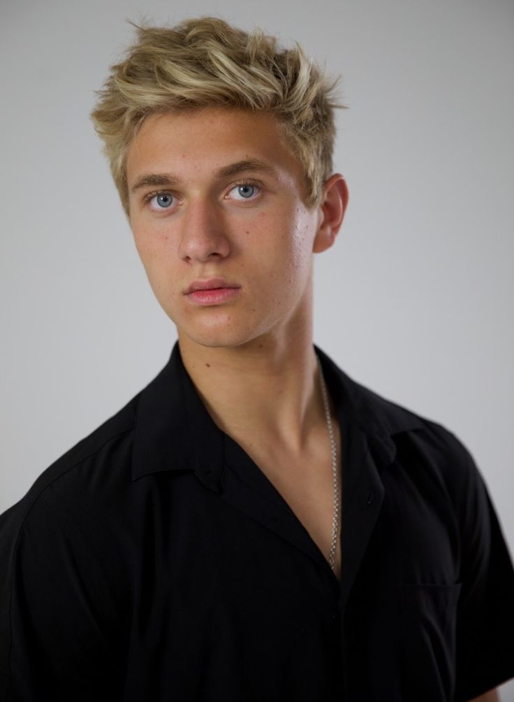 a young man with blonde hair wearing a black shirt