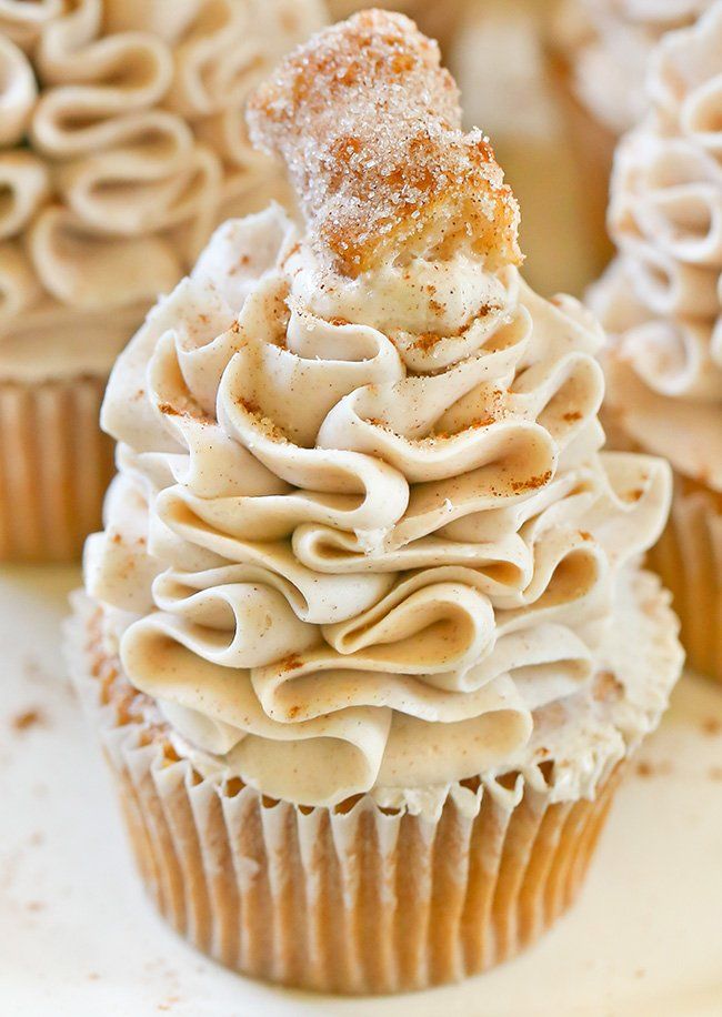 cupcakes with frosting and cinnamon sprinkles on top are arranged in the shape of a christmas tree