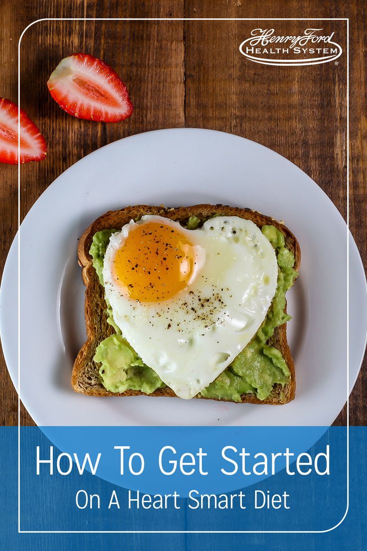 an egg in the shape of a heart on toast with strawberries and avocado