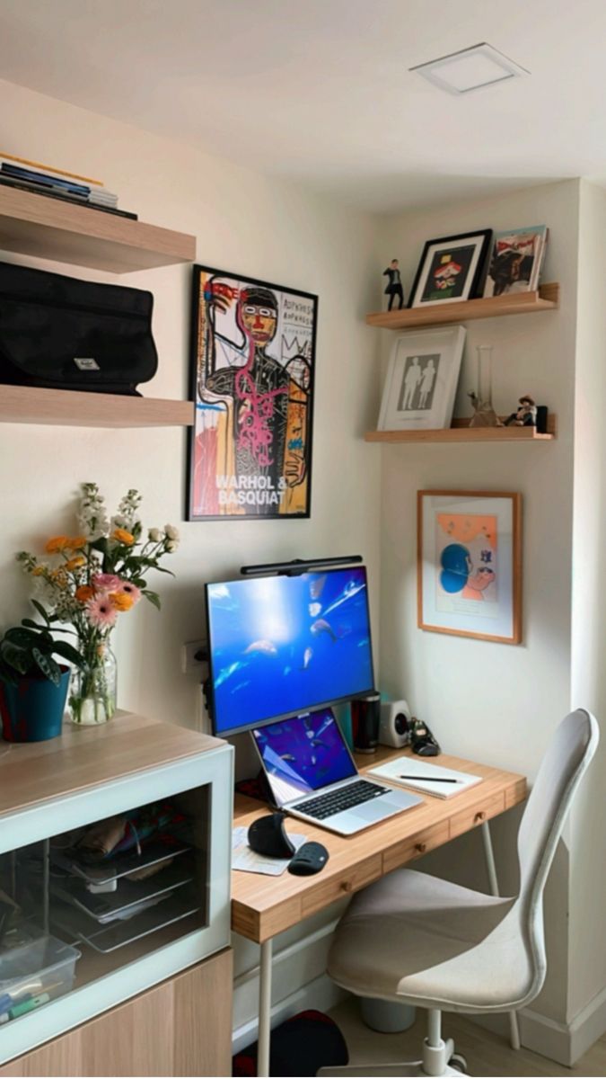 a computer desk with a laptop on top of it next to a shelf filled with pictures