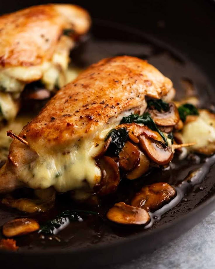 a close up of food on a plate with broccoli and mushrooms in it