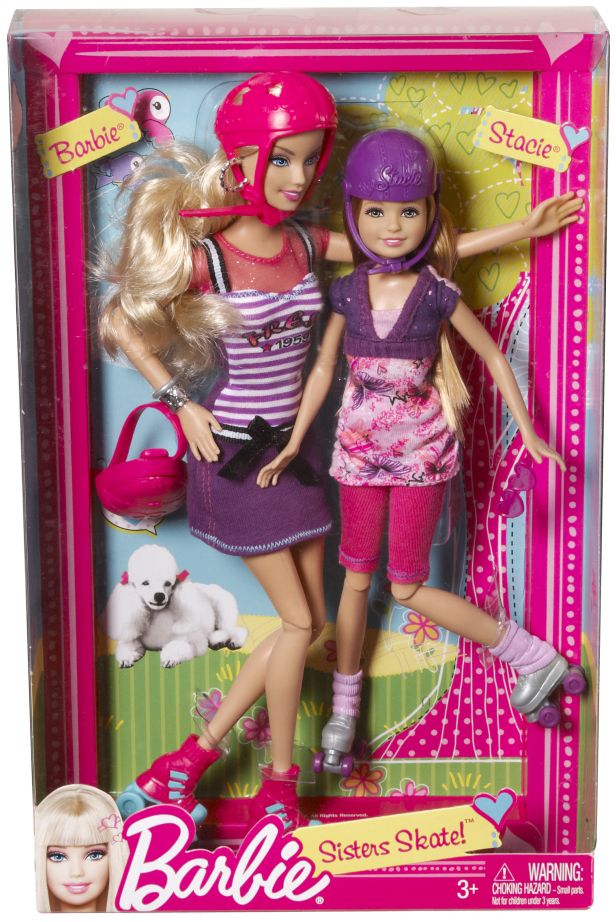 two barbie dolls are in a pink box