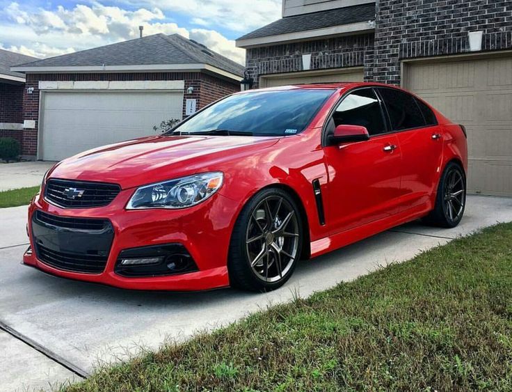 a red car parked in front of a house