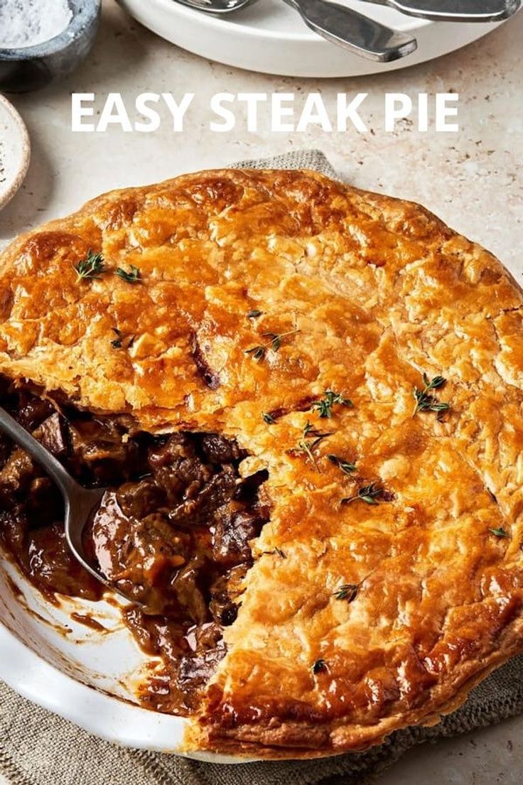 an easy steak pie on a plate with a serving spoon